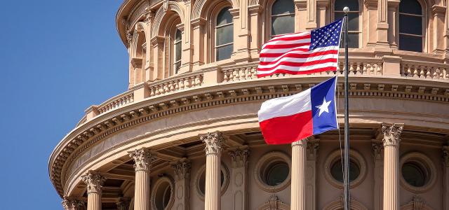 Austin capitol building with state and federal flags